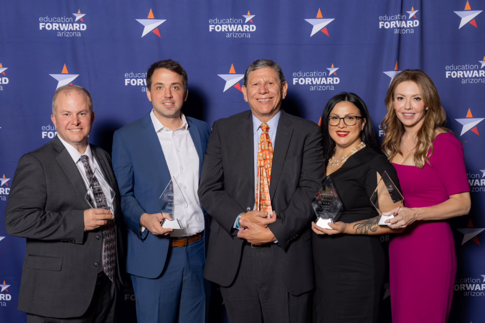 Five people holding awards, standing in front of an "Education Forward Arizona" backdrop