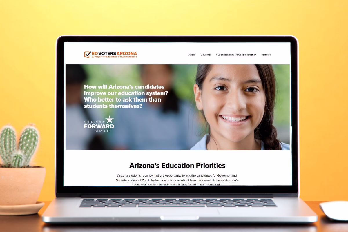 Website on a laptop screen with text about Arizona's education system and a smiling student, cactus in the background