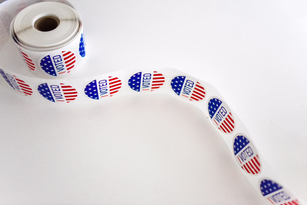 Roll of "I Voted" stickers with American flag design, related to Arizona education ballot measures
