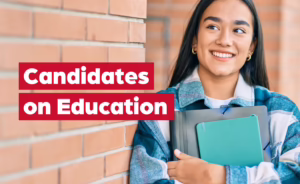 Candidates on Education: smiling student holding books beside a brick wall